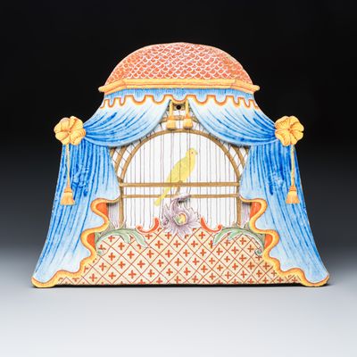 An unusual large polychrome Dutch Delft 'Birdcage behind curtains' plaque, 18th C.